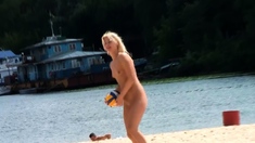 Adorable nudist teen friends enjoy sunbathing at the beach
