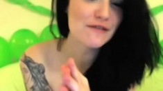 Goth chick with trashy tattoos gets flirty during a webcam show